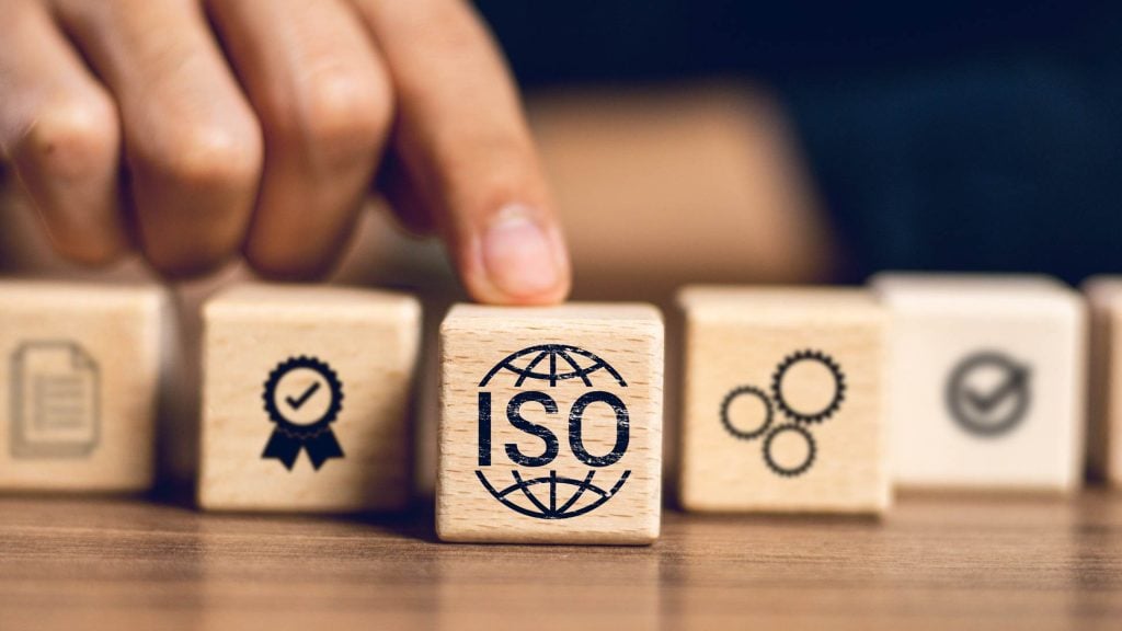 Hand with blocks depicting ISO certification