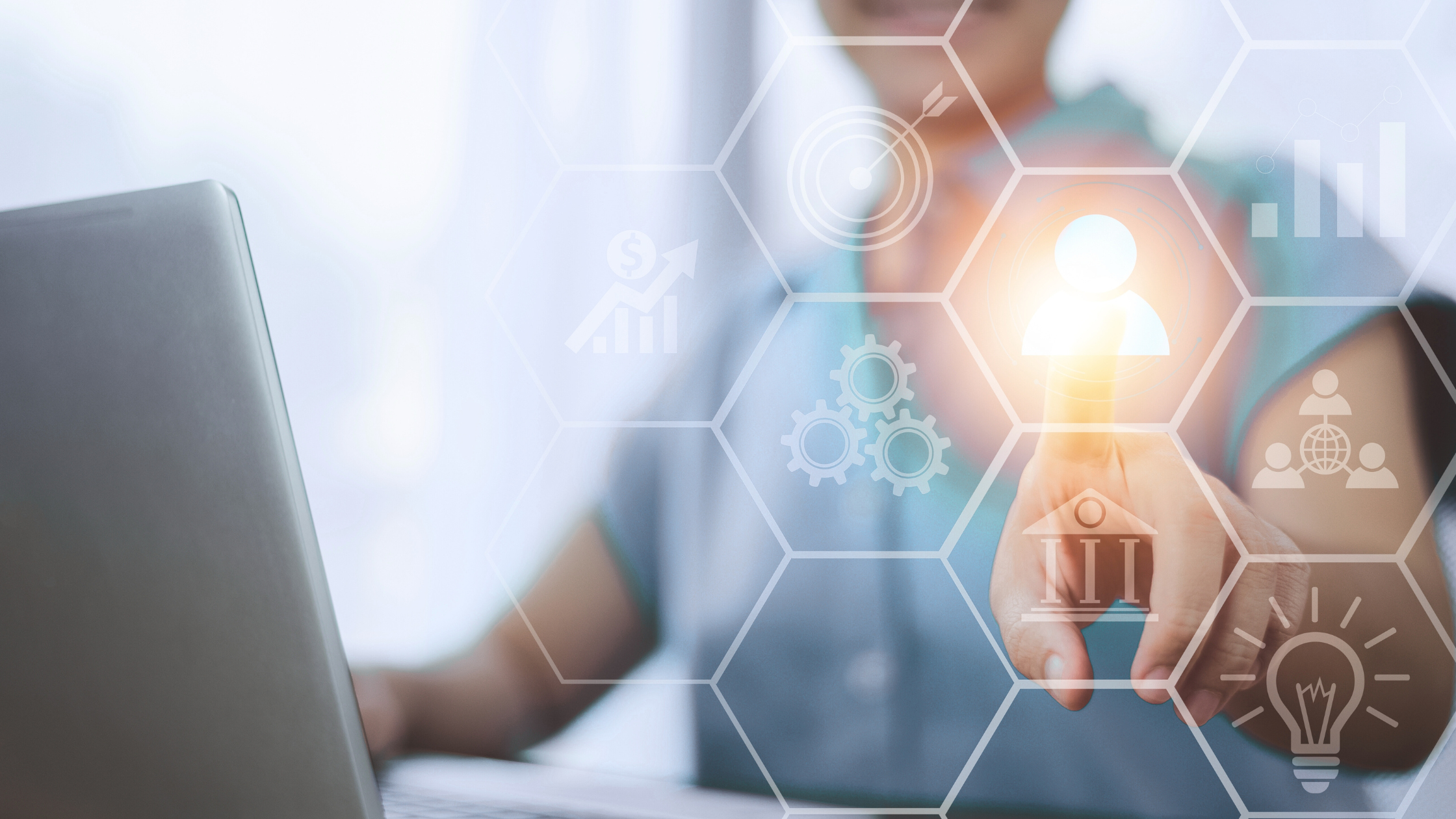Rethinking Customer Centricity image of a medical professional sitting at a laptop pointing to a virtual screen with a customer icon at its center.